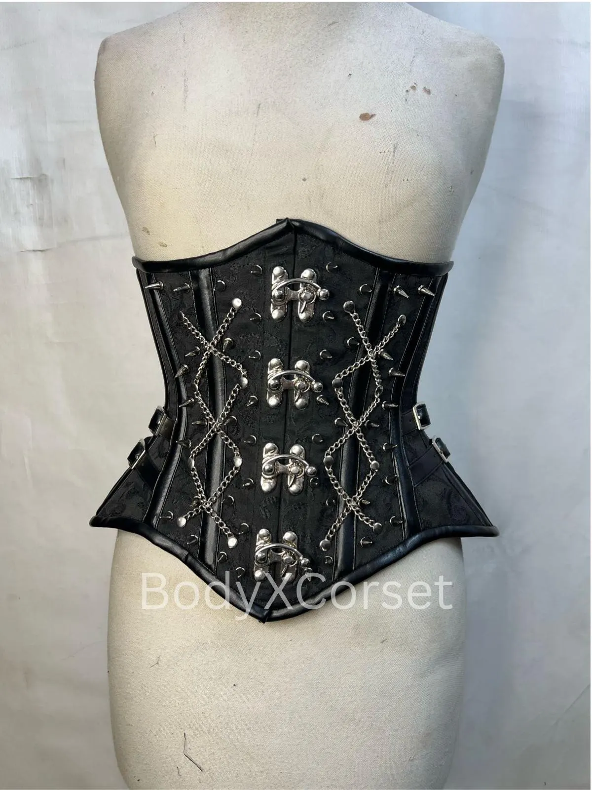 Black Brocade Gothic Underbust Corset with silver chains and steel boning on a mannequin. Black Brocade Gothic Underbust Corset with silver chains and steel boning on a mannequin curycorset.com
